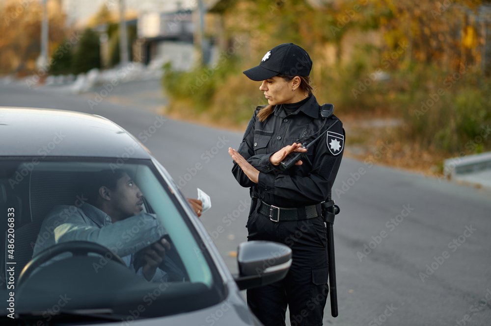 Wall mural female police officer refuse bribe from driver