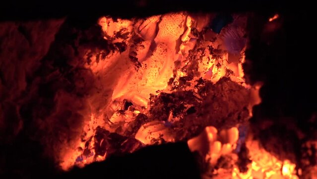 Burning hot embers of a wood fire in solid fuel boiler