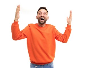 Naklejka premium joyful happy man emotionally waving his hands gesturing with open mouth and smile
