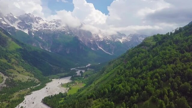 The epic Valbona National Park in the Albanian Alps, with the Valbona River winding through the valleys and mountains. Aerial flyover