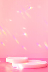 Abstract minimal scene - empty stage, cylinder podiums on soft pink background with rainbow crystal light refraction sparkles. Pedestal for cosmetic product and packaging mockups display presentation