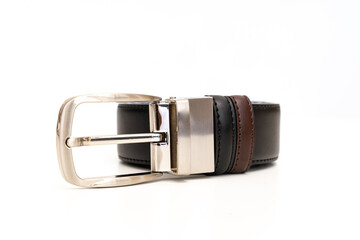 Double-sided black and brown leather belt with an unbuttoned buckle on a white background.
