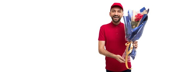 courier in red clothes with a gorgeous bouquet looking at the camera with a smile on a white background