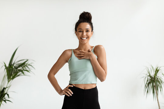 Portrait Of Happy Young Beautiful Woman In Sportswear Posing Indoors