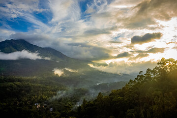 Obraz na płótnie Canvas Beautiful mountain landscape with Sunrise and passing clouds. Munnar, Kerala, India