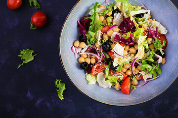 Healthy salad of chickpeas, tomatoes, olives and lettuce with red onion. Healthy food, diet. Closeup food. Top view, flat lay