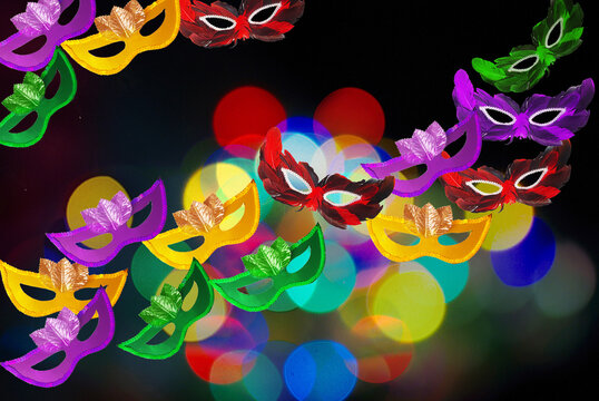 Carnival masks on a blurred colored background. Symbol of carnival, holiday. Place for text. 