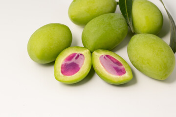 Close-up raw marina plum or green plum mango with purple seed asia tropical fruit sour taste.