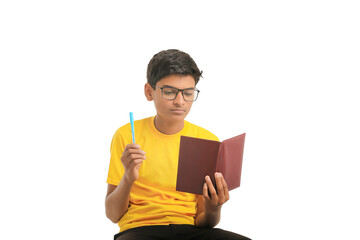 Indian boy holding diary in hand and thinking some idea on white background.