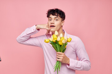 A young man Bouquet of yellow flowers romance posing fashion isolated background unaltered