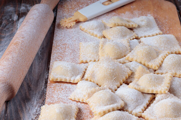 Close-up view of fresh Homemade Ravioli on Wooden Background. Selective focus.