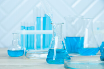 Laboratory glassware with blue liquid in a test tube. scientific laboratory flasks, droppers, Petri dishes, beakers and cylinders, laboratory equipment