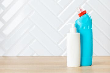 Set of cleaning supplies on table indoors. Household chemicals