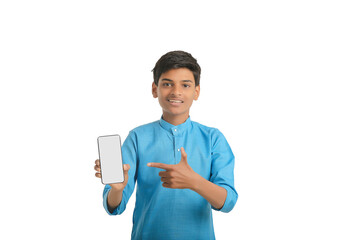 Indian little child in traditional wear and showing smartphone