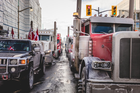 Convoy for Freedom 2022 Trucks and Tracors Protesting in the Streets with Flag and Signs.