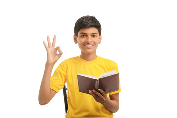 Indian boy with diary on white background.