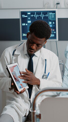 Doctor explaining heart diagnosis with cardiology image on digital tablet. Medical specialist...