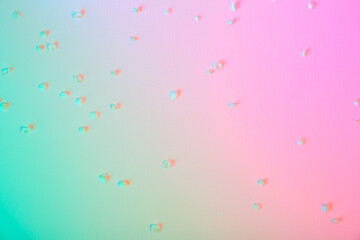 Gradient from pink to green tint background with fallen white petals of cherry or apple tree flowers. Easter holiday card with neon light. Spring wallpaper. Minimalism style. Fresh girlish color.