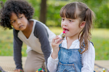 Fototapeta premium cute little girl playing makeup.
