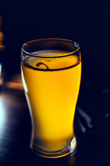 Glass glass of beer and breaded onion rings on a bar counter