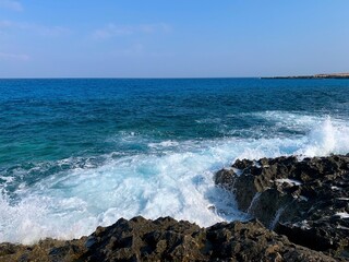 Rocky coastline, vivid sea and beautiful bright sky 