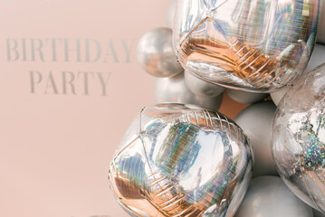 Round pink photo zone made of silver balloons with space to copy your text. Party decorated with balloons