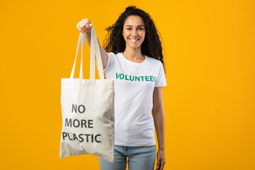 Volunteer Lady Showing Shopper With No More Plastic Inscription, Studio