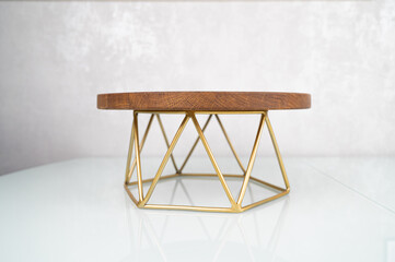 Empty wooden stand for cakes, sweets, pastries. Stylish wooden cake stand on a metal base