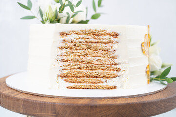 Wedding cake cutaway, cutaway piece of cake. Wedding layer cake with decorations on wooden stand