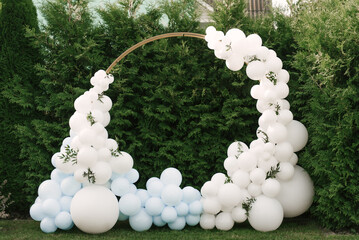 Decorations for holiday party. A lot of balloons blue and white colors. Round photo zone with balls