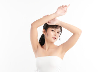 Obraz premium Beautiful Young Asian woman lifting hands up to show off clean and hygienic armpits or underarms on white background, Smooth armpit cleanliness and protection concept