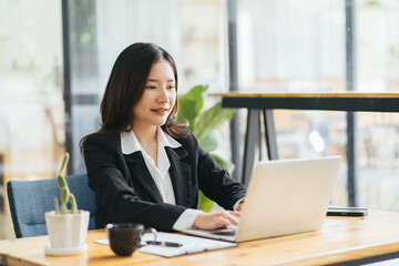 Photo of young cheerful positive good mood smiling happy businesswoman working in computer at office workstation