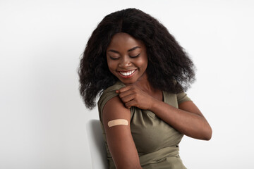 Closeup of black woman showing adhesive band on shoulder