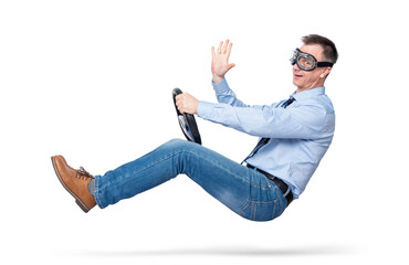 Happy young man in stylish goggles driving a car sends greetings to the camera, isolated on white...