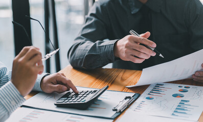 Business and investment concept. Business people discussing the charts and graphs showing the results of their successful teamwork.