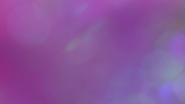 Blurred soft trendy holographic neon purple pink background. Highlights and bokeh