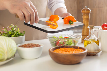 man preparing healthy vegetarian food  on  table in  kitchen