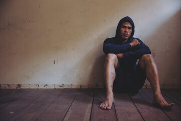 sad man sitting alone in the dark.