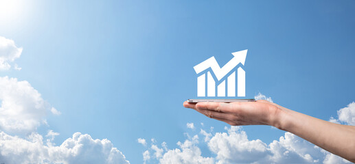 Male hand holding smart mobile phone with graph icon.checking analyzing sales data growth graph...