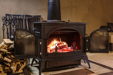 burning wood in the stove in a country house - 486224614