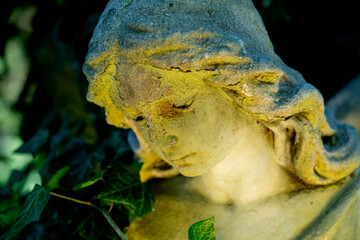 Angel. Fragment of an ancient statue. Close up. Horizontal image.