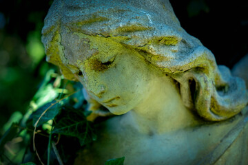 Dramatic facial expression of beautiful angel. Fragment of an ancient statue. Close up. Horizontal...