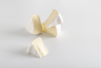 camembert cheese on a light surface.