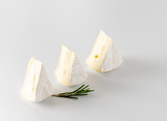 Camembert cheese pieces on a light surface