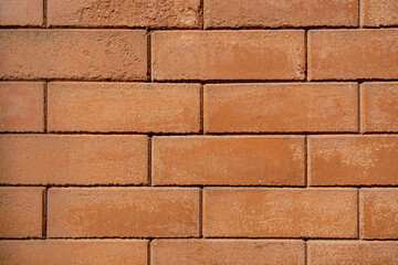 Detail of orange brown brick wall pattern in outdoor sunlight