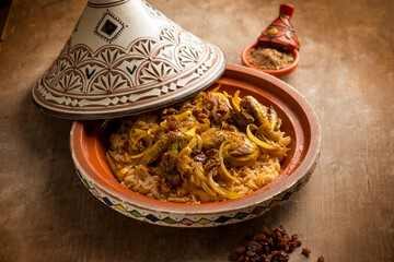 traditional moroccan chicken tajine with vegetables and dried grapes - 486227805