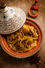 traditional moroccan chicken tajine with vegetables and dried grapes - 486227864
