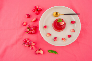 Jelly dessert with Fresh organic Carunda or Karonda fruits on pink background