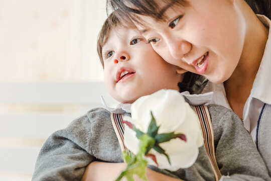 child little boy and mom with white rose to the mother ,Mother's day, People family learning lifestyle concept.