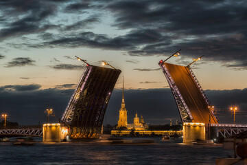 Fototapeta na wymiar Russia. Open Palace Bridge and view of the Peter and Paul Fortress in St.Petersburg in white night